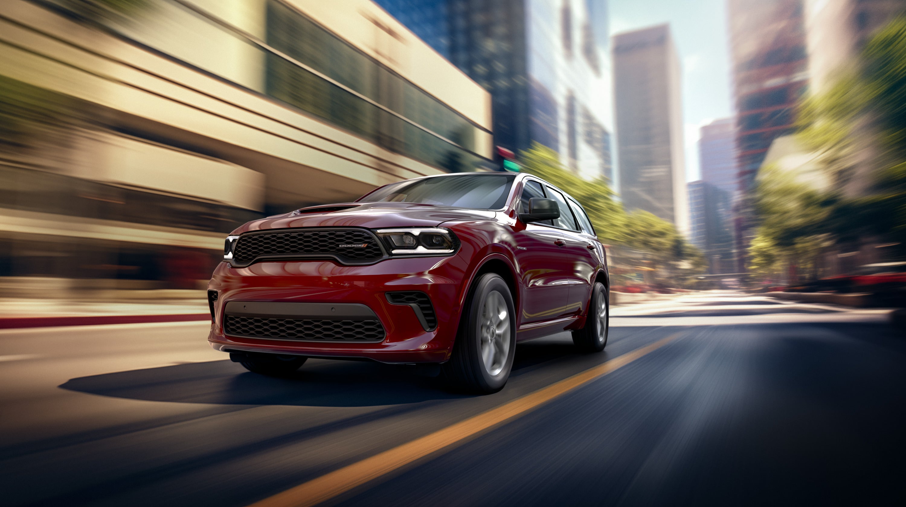 a red dodge durango driving in the city