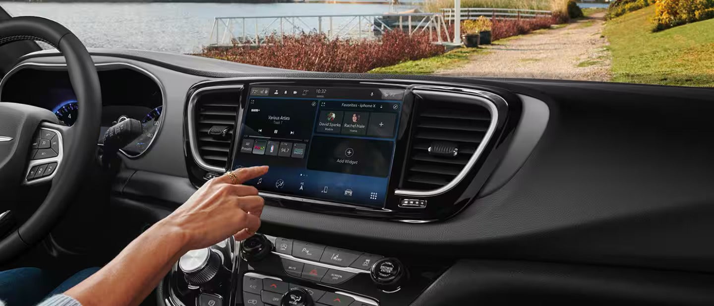 a person updating the infotainment system on a chrysler voyager