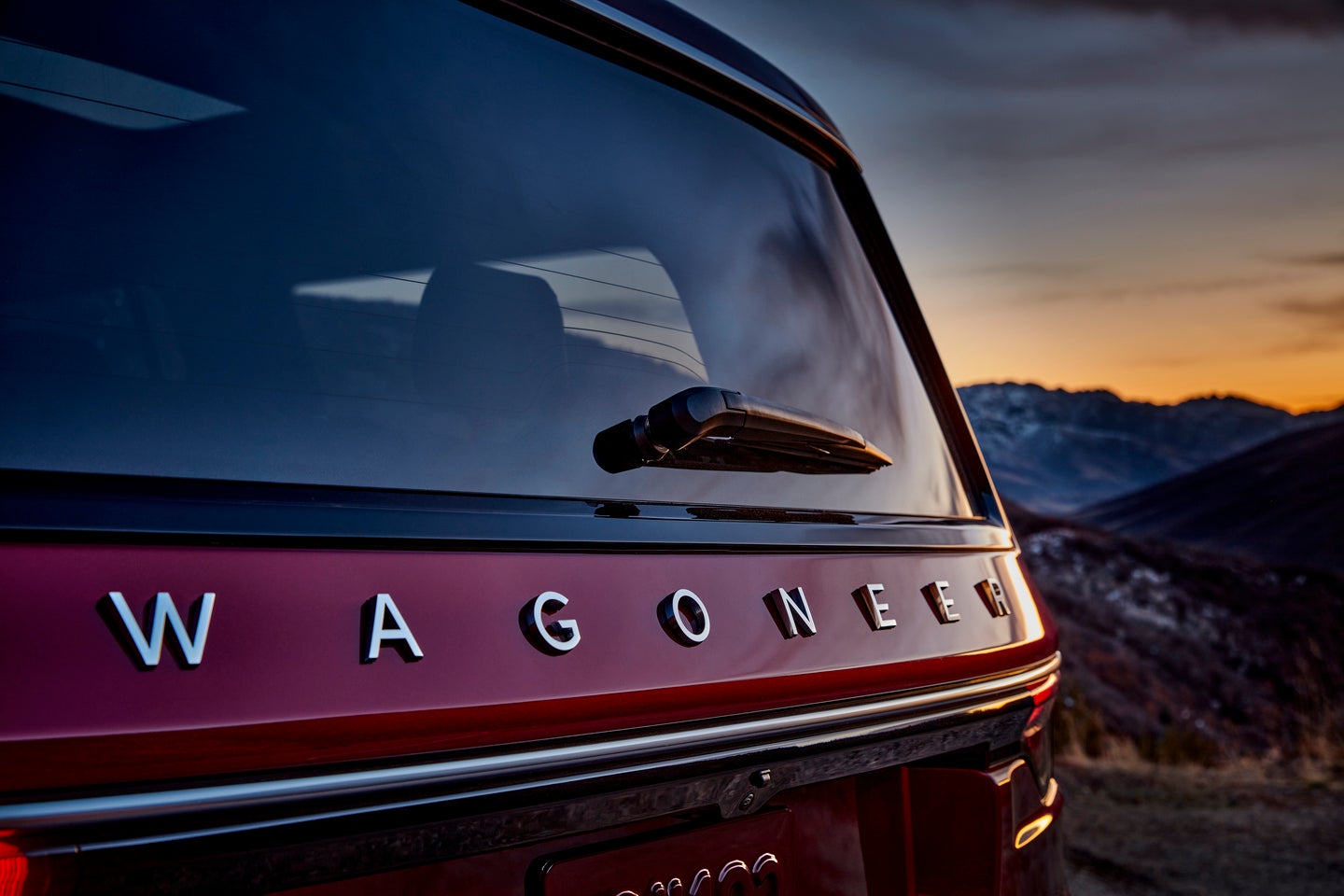 up close of the wagoneer emblem on the back of a red 2025 jeep wagoneer