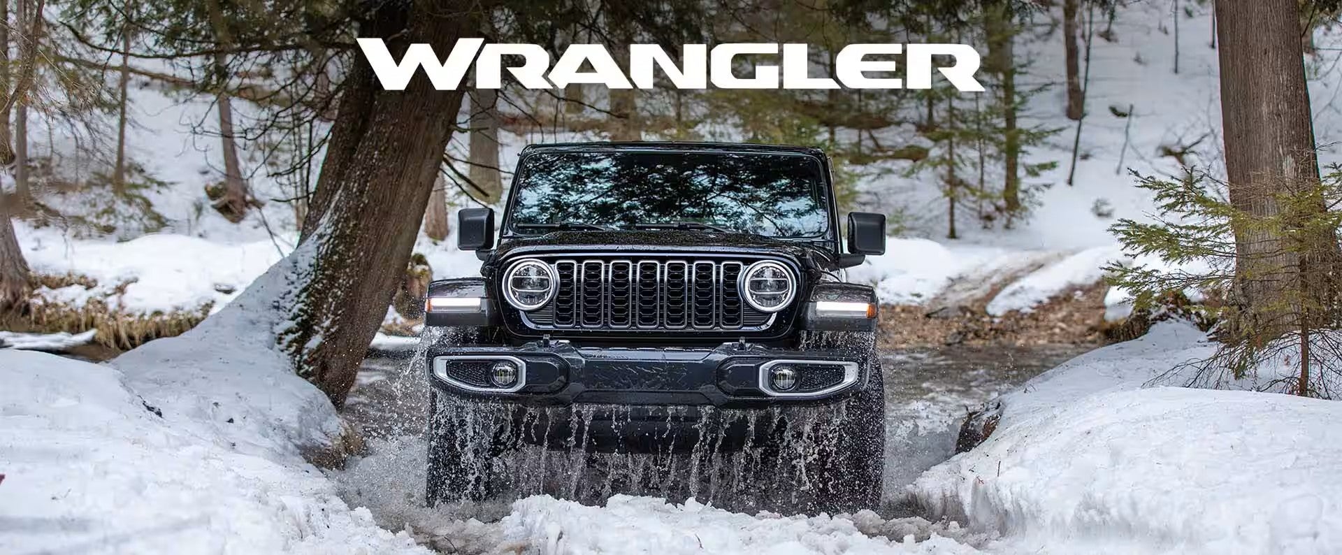 a jeep wrangler driving through water and snow