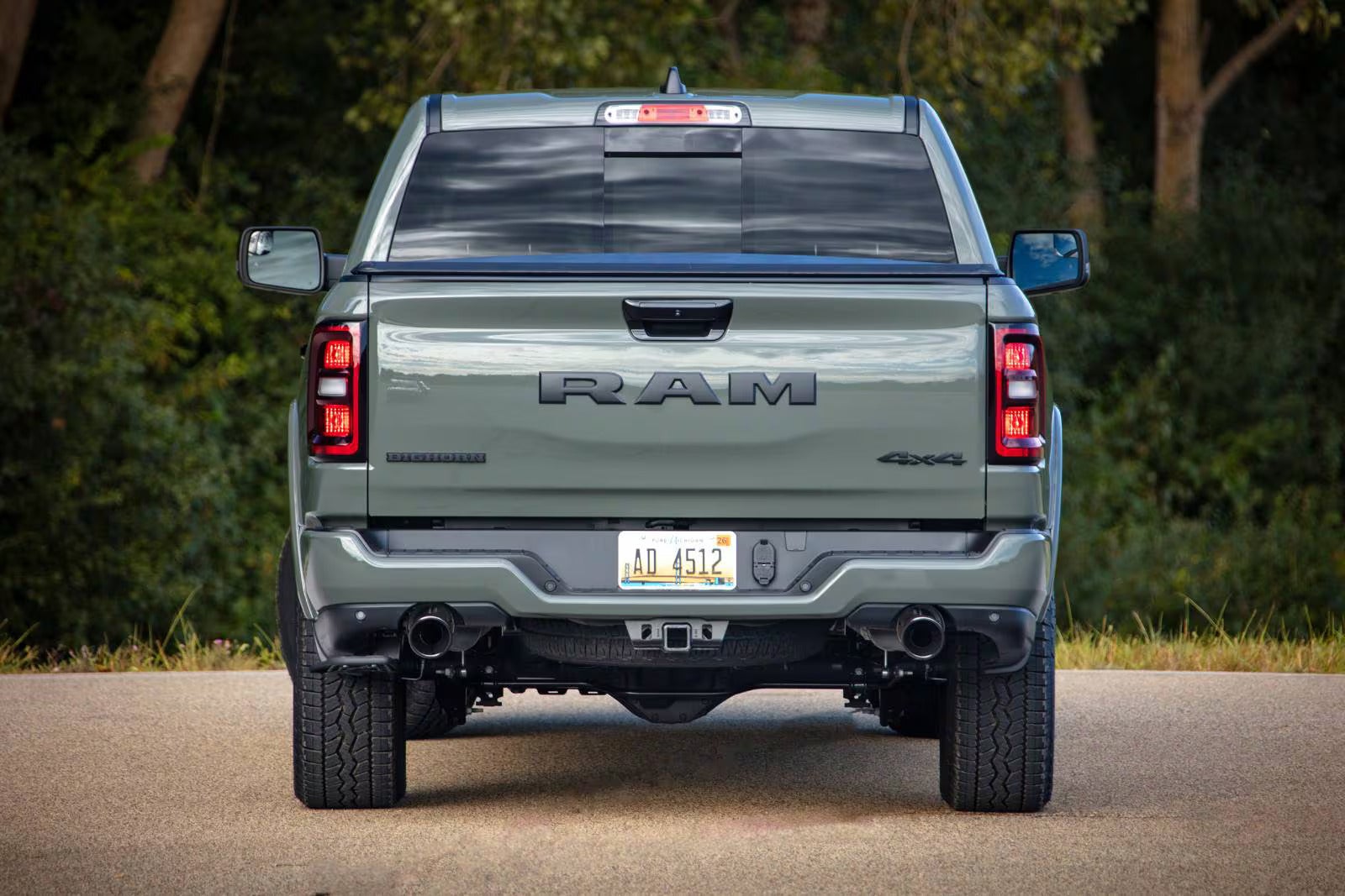 the back of a ram 1500 parked next to trees