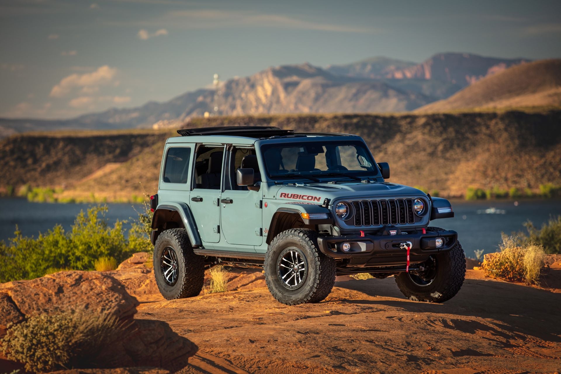 a 2025 jeep wrangler parked on a rugged terrain in the dessert