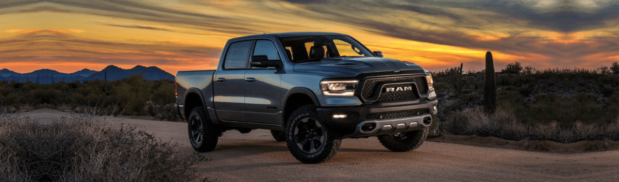 A gray 2019 RAM sitting on a road during a golden sunset.