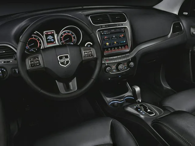 The inside driver side steering wheel and dash of the new Dodge Journey.